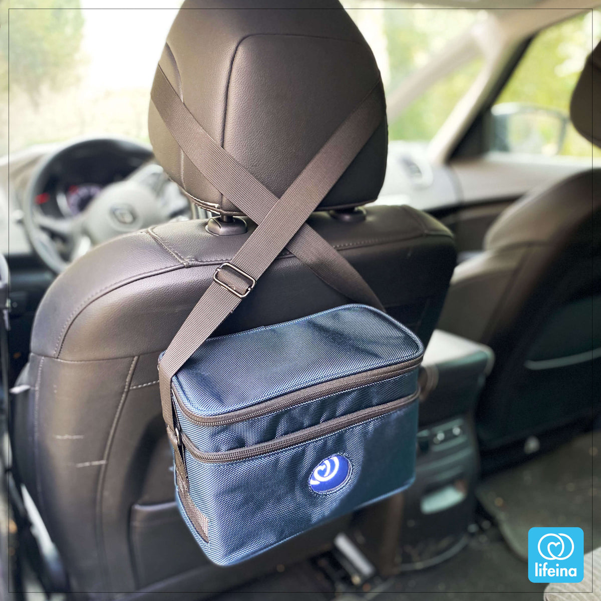 electric medication cool box and shoulder bag in a car
